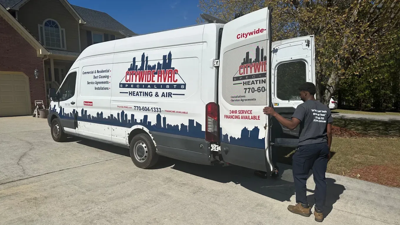 Ultimate Guide to AC Repair & Troubleshooting 2 Homeowner checking thermostat settings while troubleshooting an air conditioner